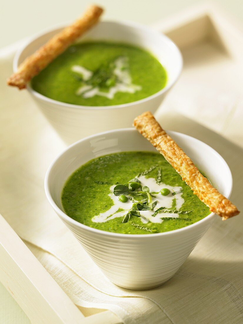 Pea soup with cream and breadsticks