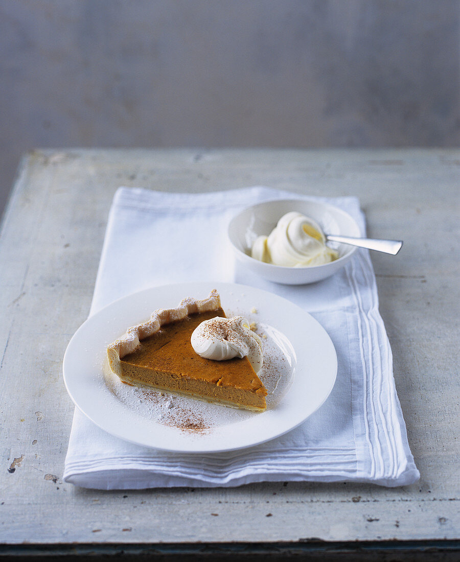 Pumpkin pie with a dollop of cream