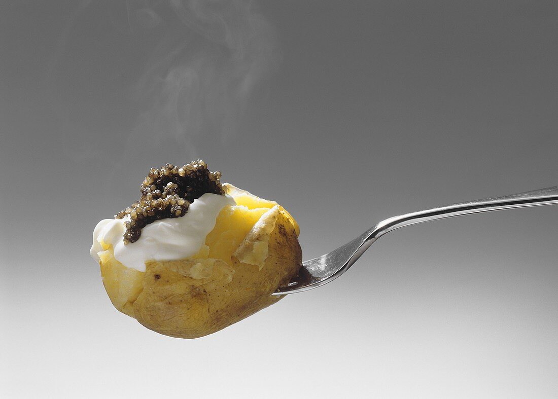Potato with Sour Cream and Caviar on a Fork