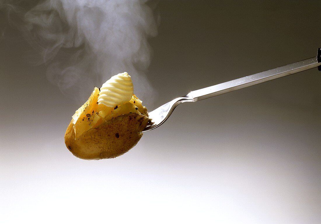Steaming Potato in Skin on Fork with Butter
