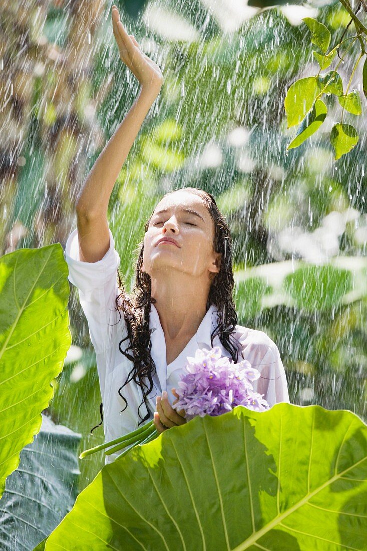 Young woman in summer rain