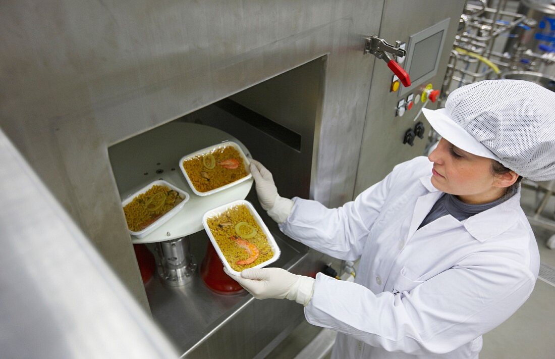 Food technician testing microwaved food