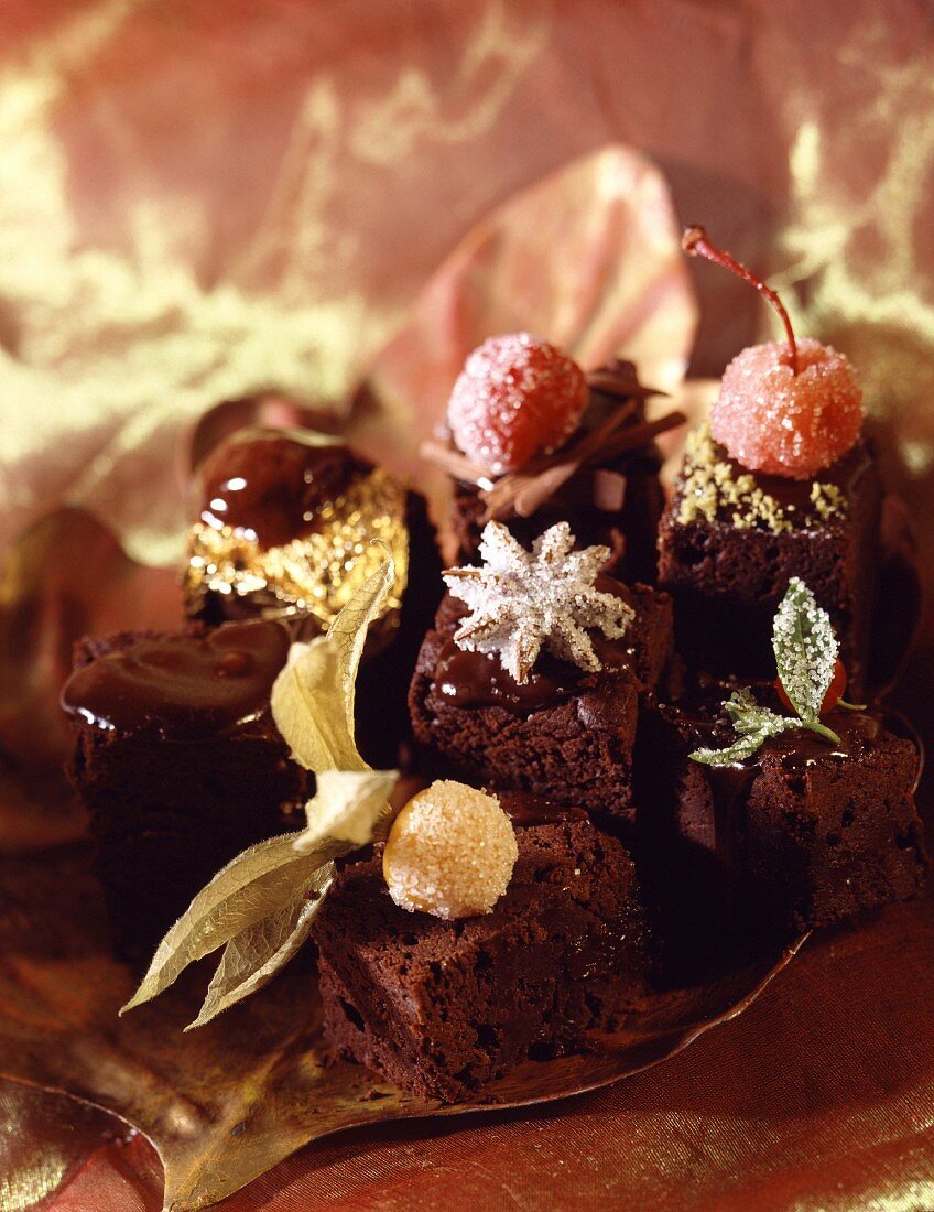 Fancy chocolate cakes decorated with candied fruit