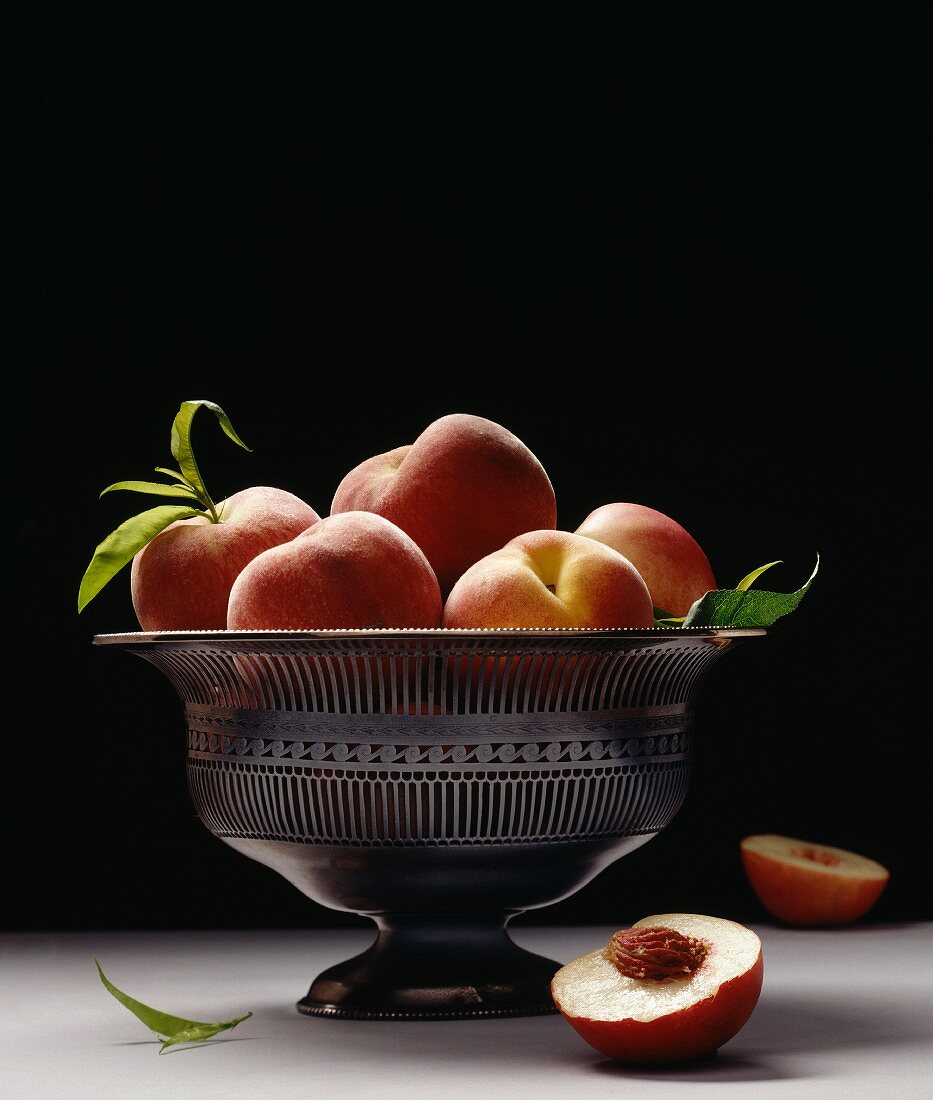 silver bowl of peaches