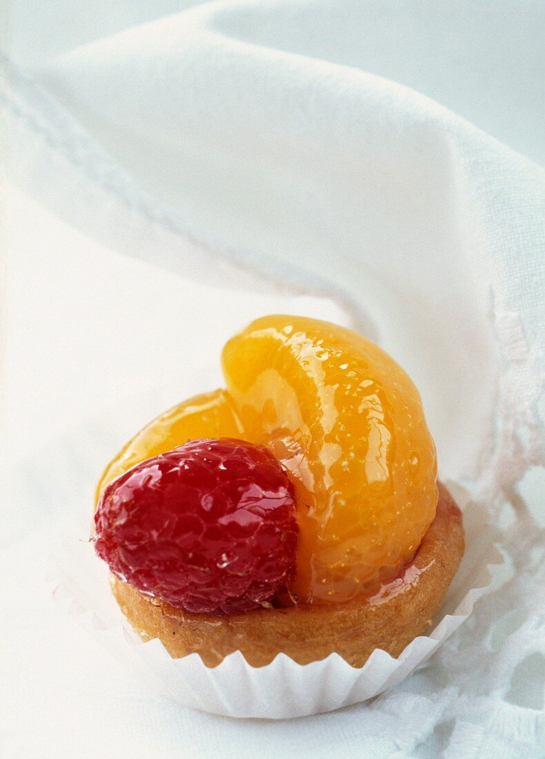 A petit four with raspberries and clementines