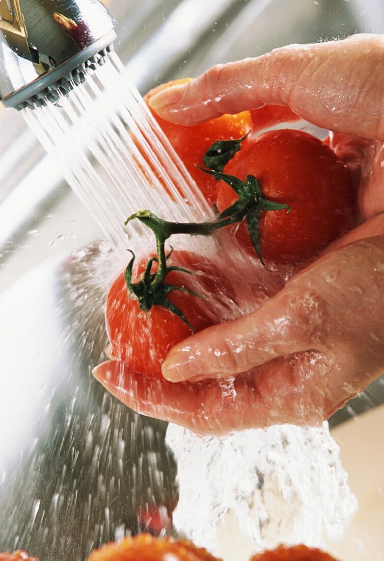 rinsing tomatoes under tap