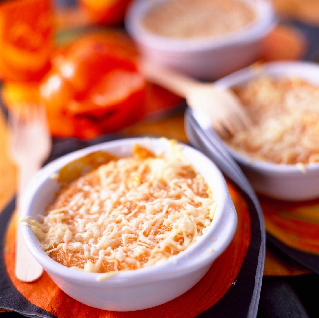 Individual pumpkin and tomato cheese-topped dish