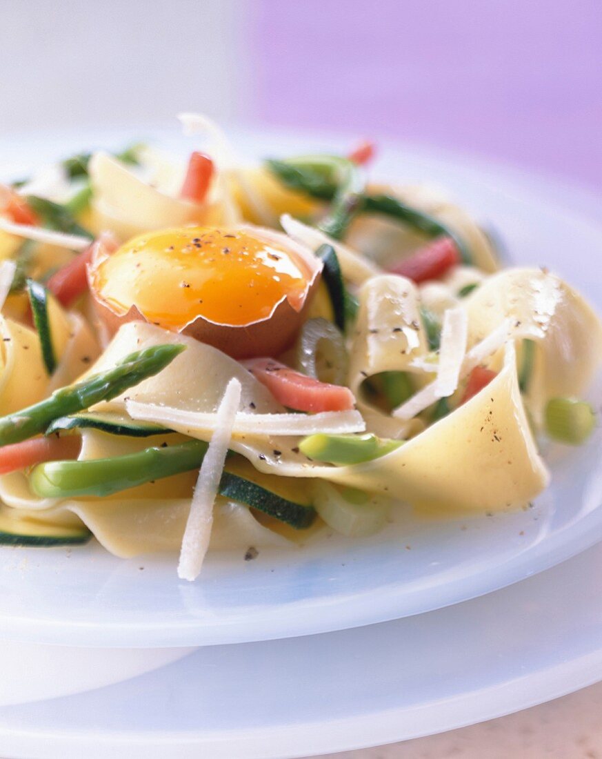 Pasta with vegetables and raw egg