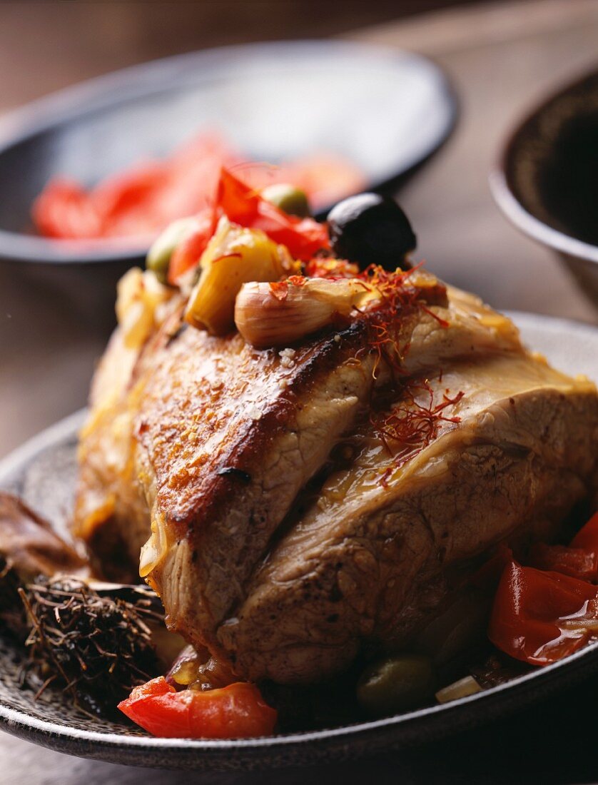 Veal rib with tomatoes and olives and saffron