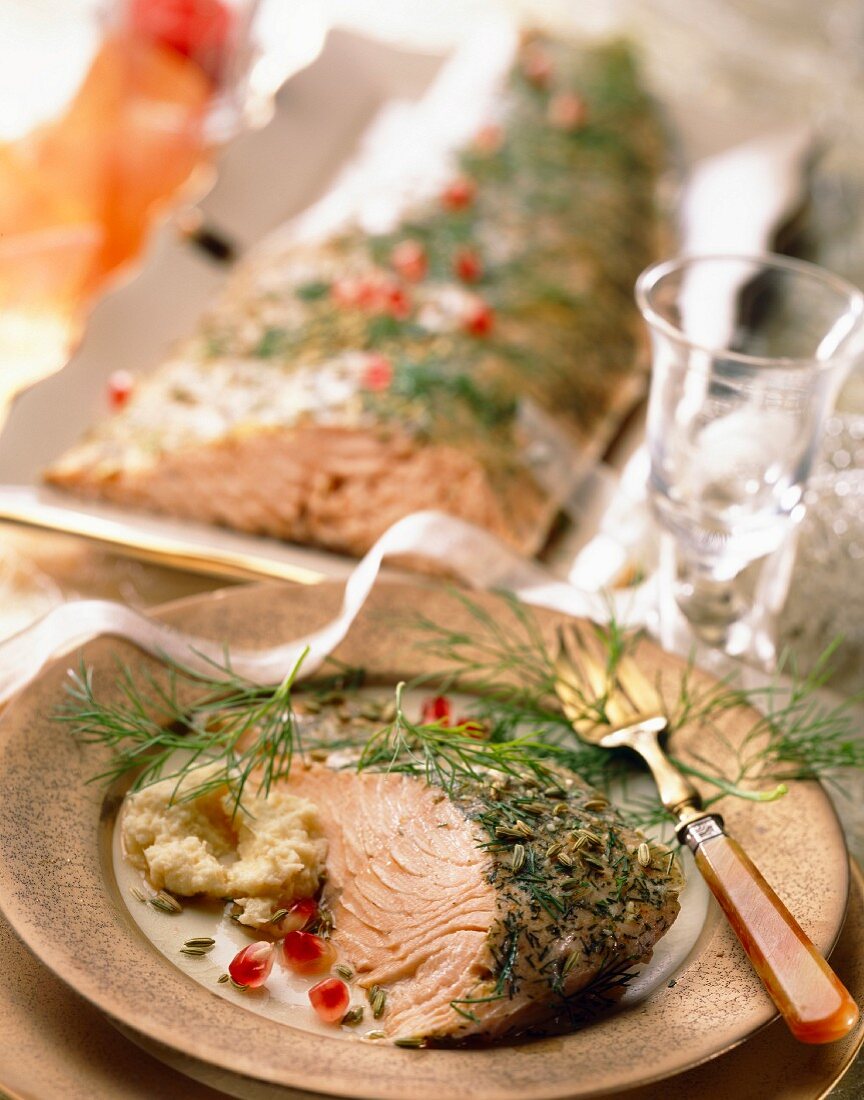 Salmon with herbs, cream of garlic and pomegranate