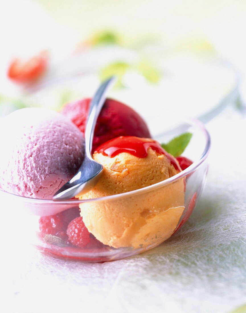 Scoops of ice cream with raspberry sauce