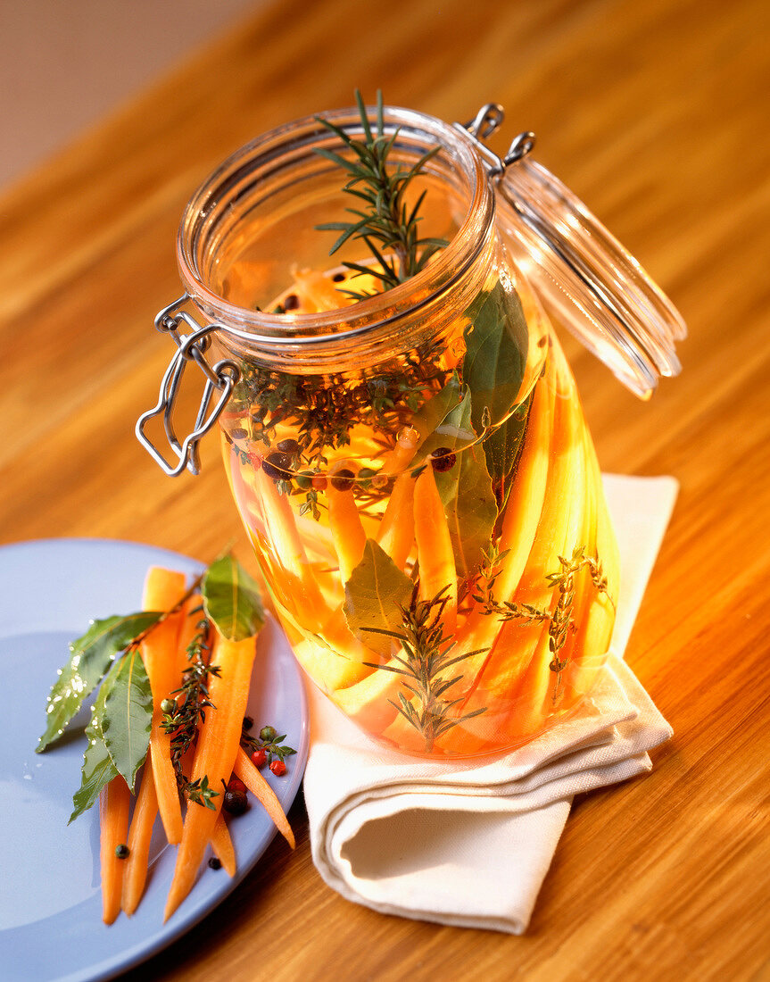 Jar of carrots marinated in herbs