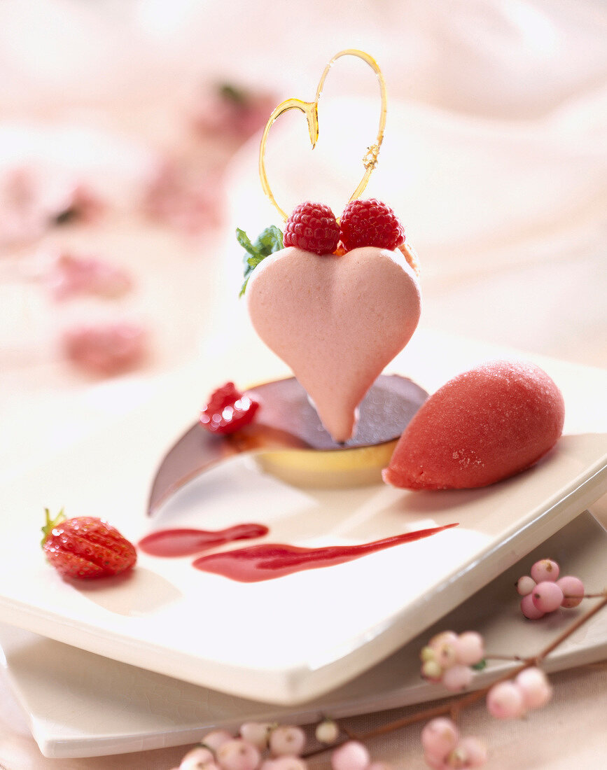 Heart-shaped, pink macaroon with summer fruit for St Valentine's Day