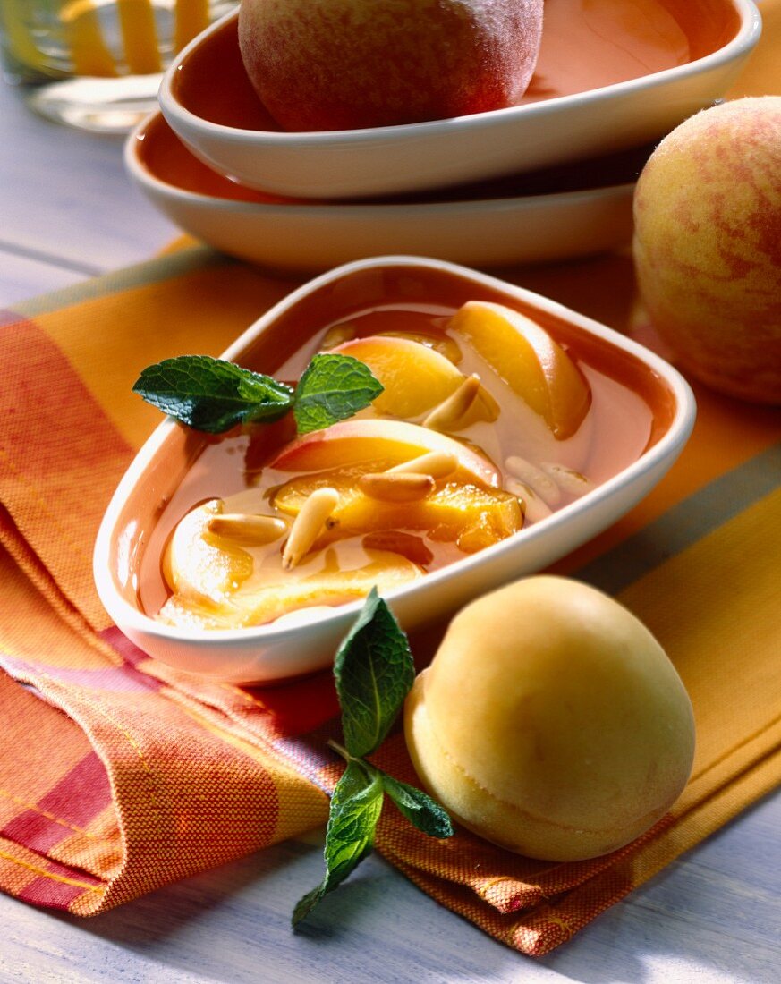 Peaches in syrup with pine seeds