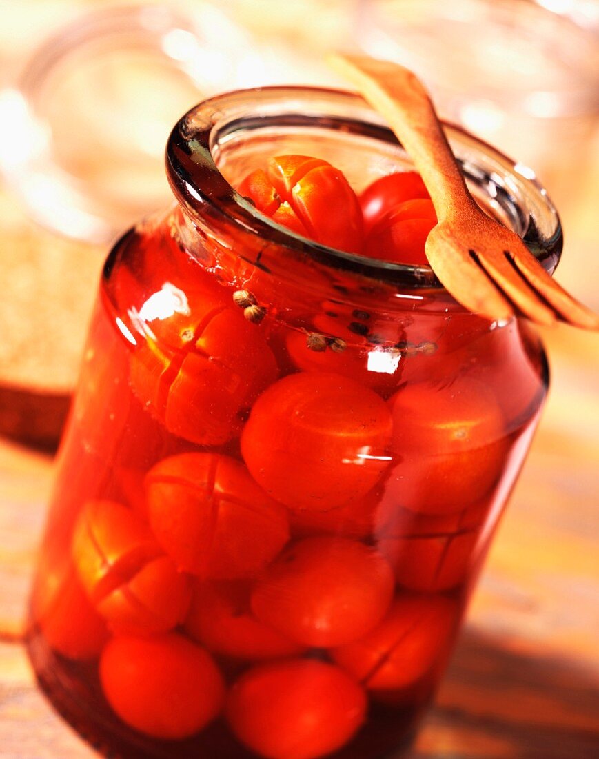 Jar of cherry tomatoes in spicy vinegar