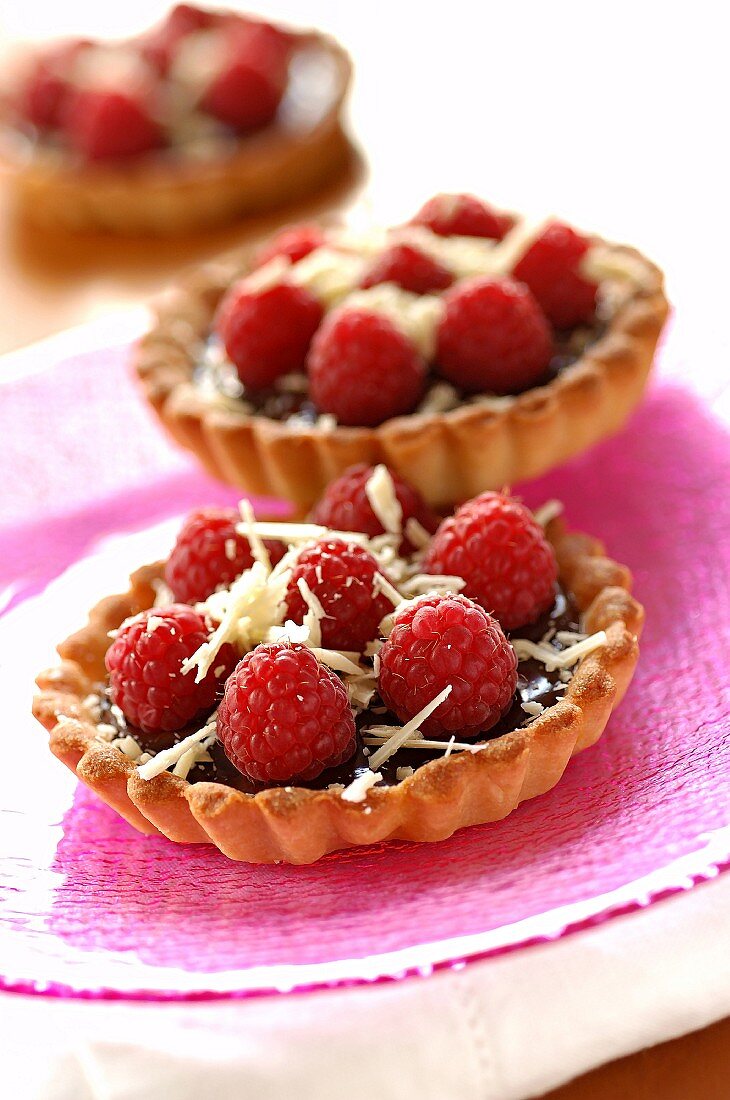 Inidividual plain chocolate and raspberry tarts