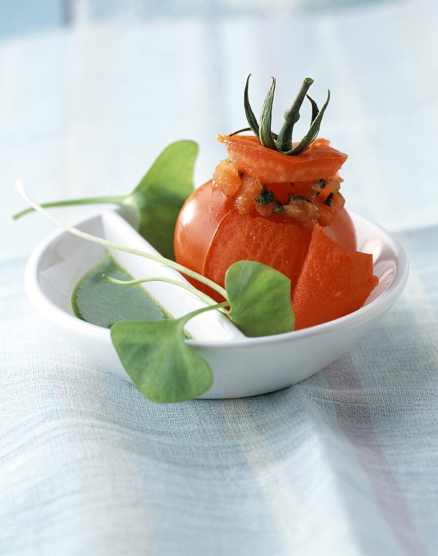 Stuffed tomato, herb sauce