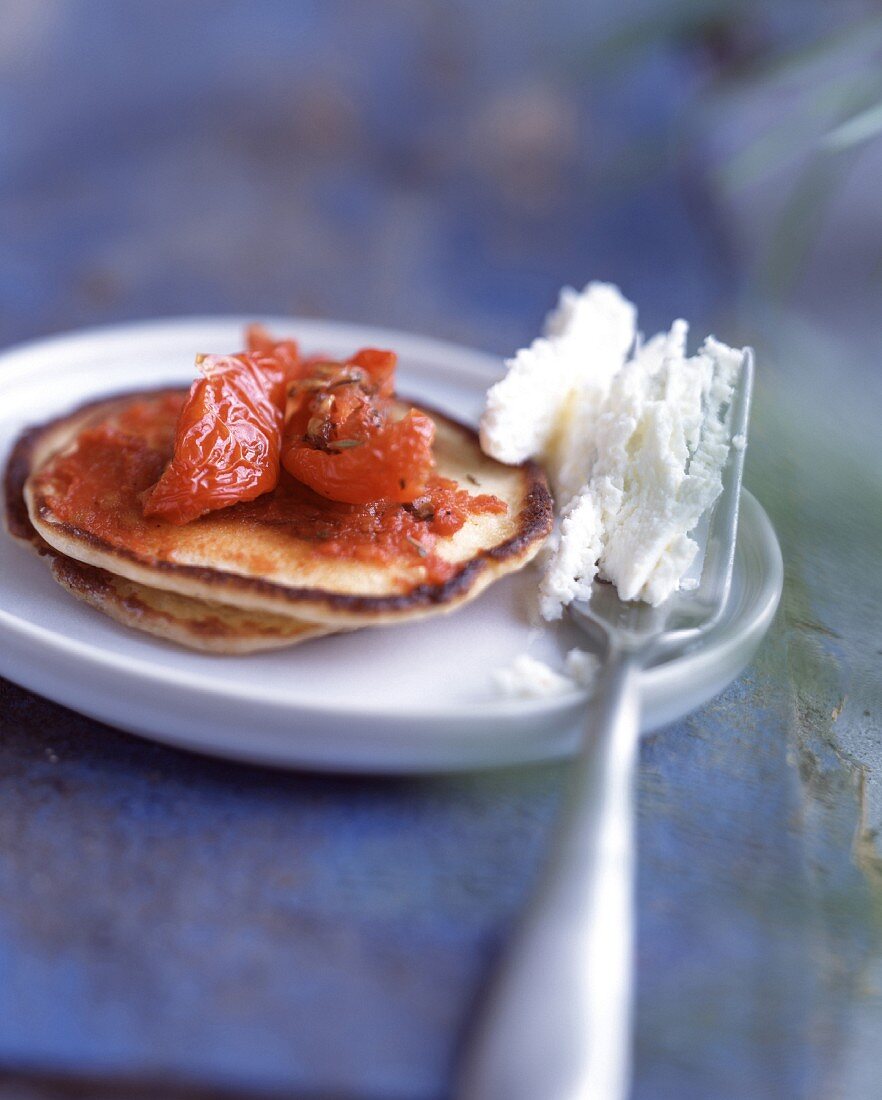 Blinis with stewed tomato caviar and Brousse cheese