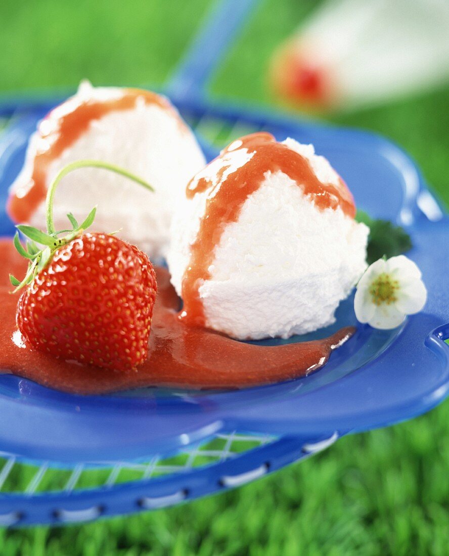 Petit suisse cheese ice cream with strawberry sauce