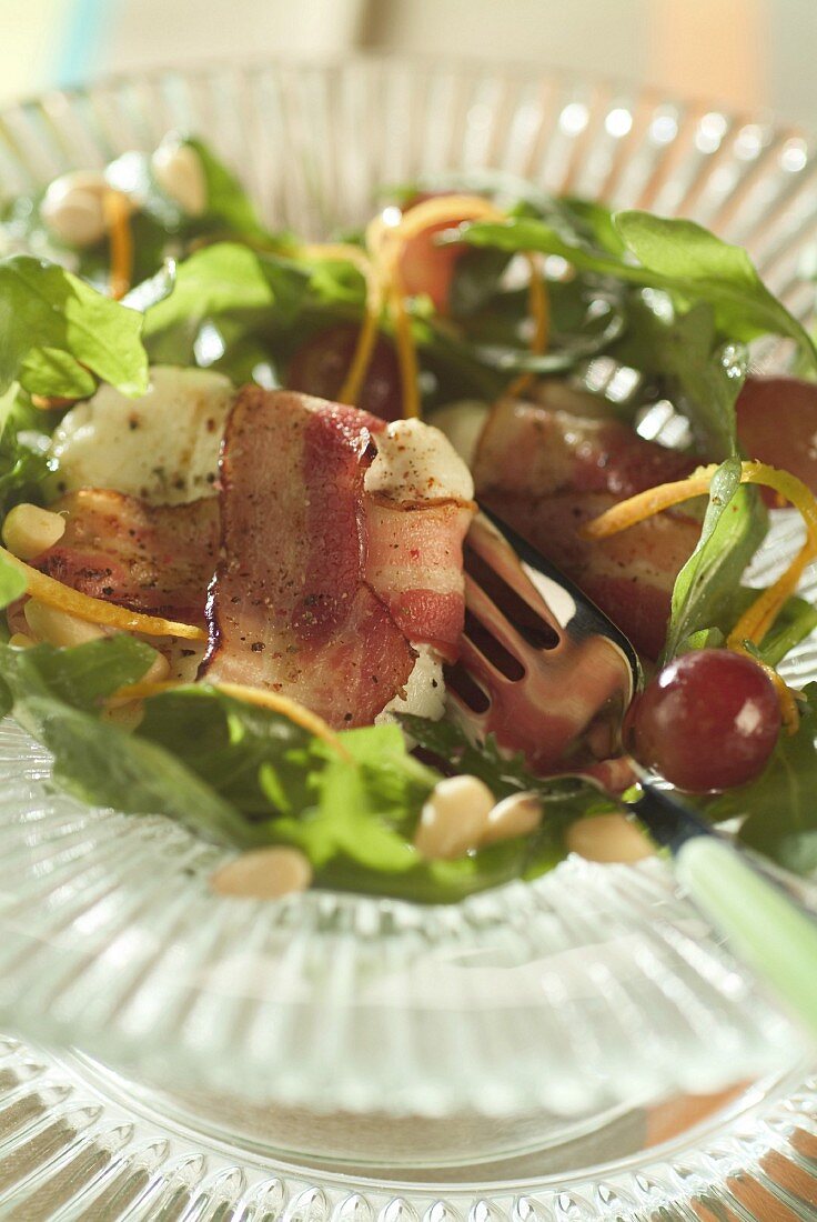 small goats in bacon on rocket salad