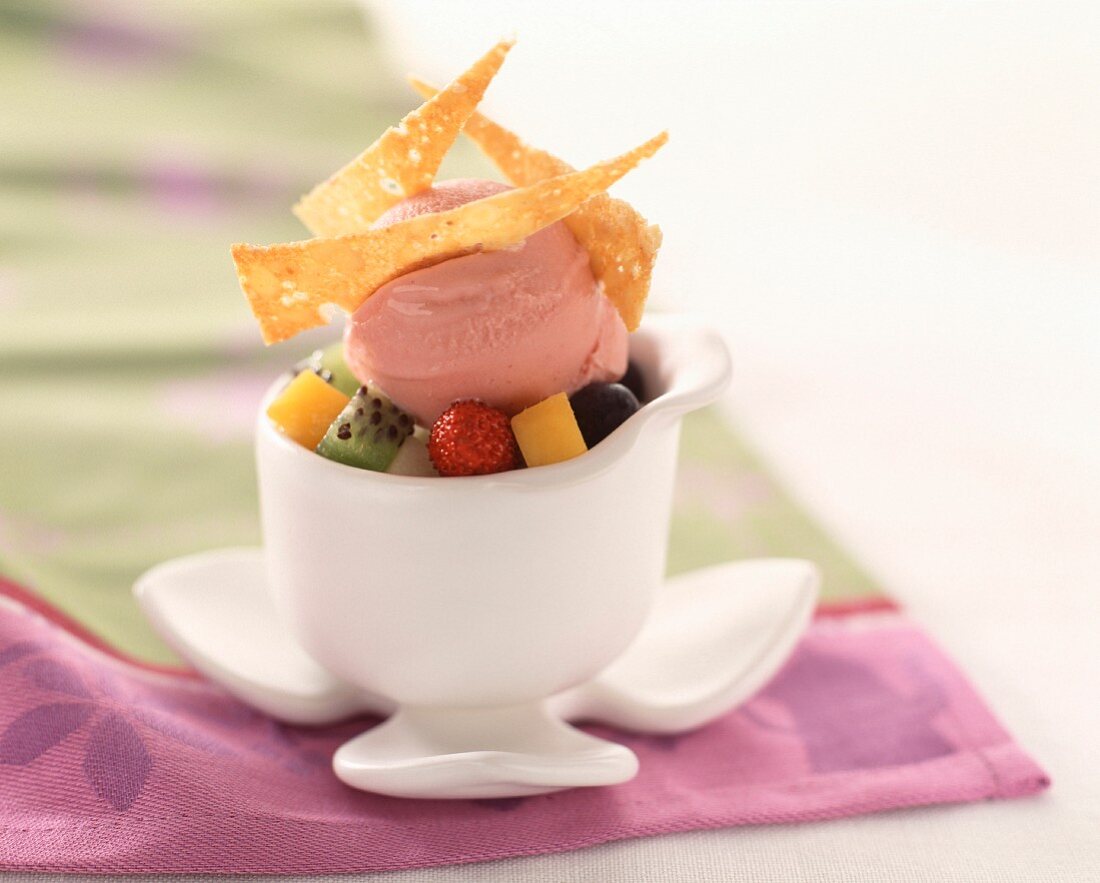 fruit salad, strawberry ice cream and pine nut triangle