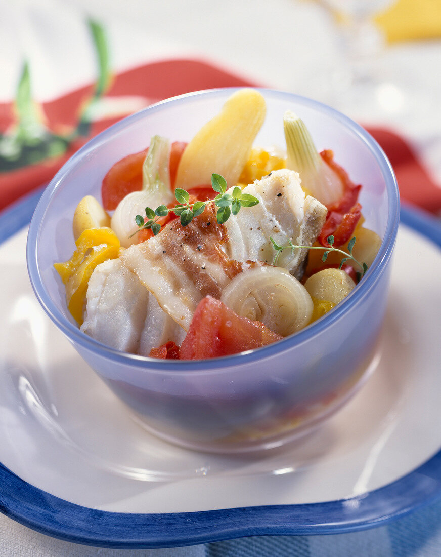 Hake, bacon, onion, tomato, potato and pepper salad