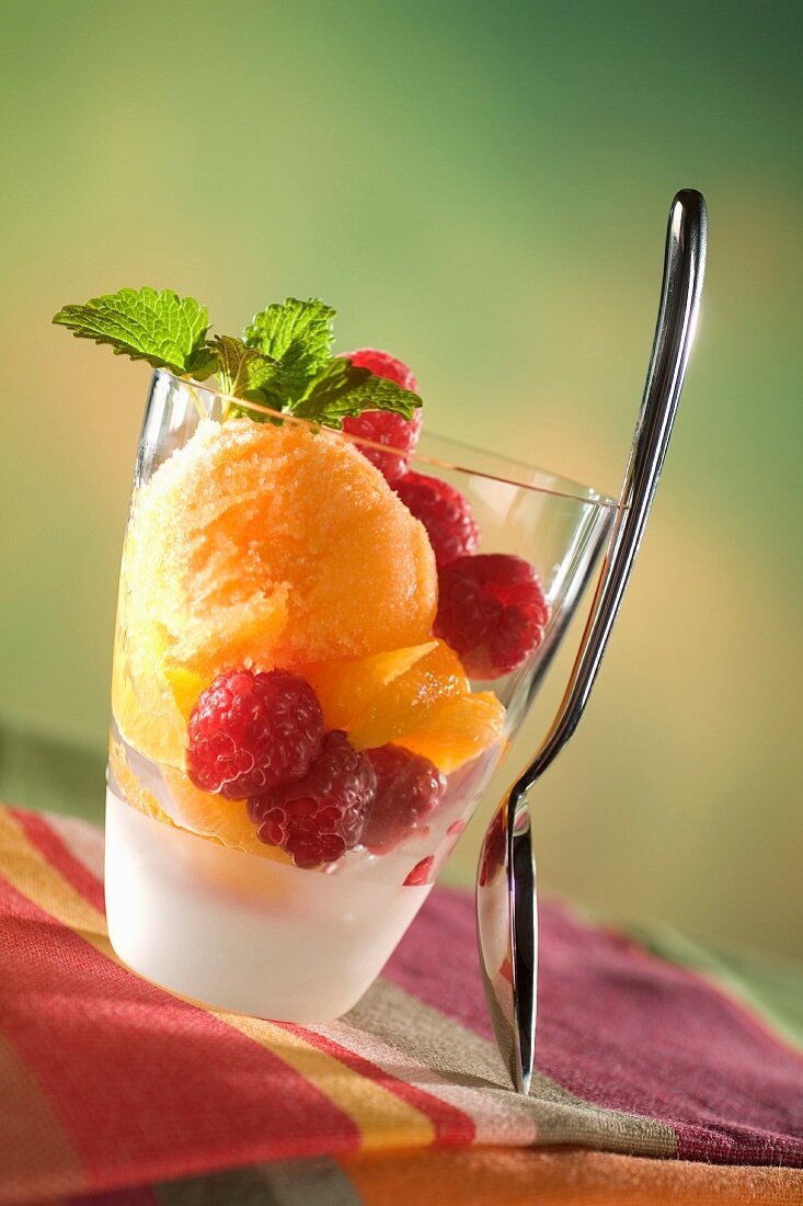 Mandarine sorbet with raspberries and lemon balm
