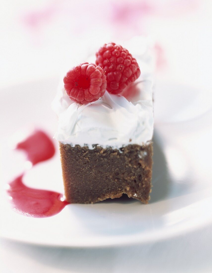 Fromage blanc mousse on chocolate sponge cake with raspberries