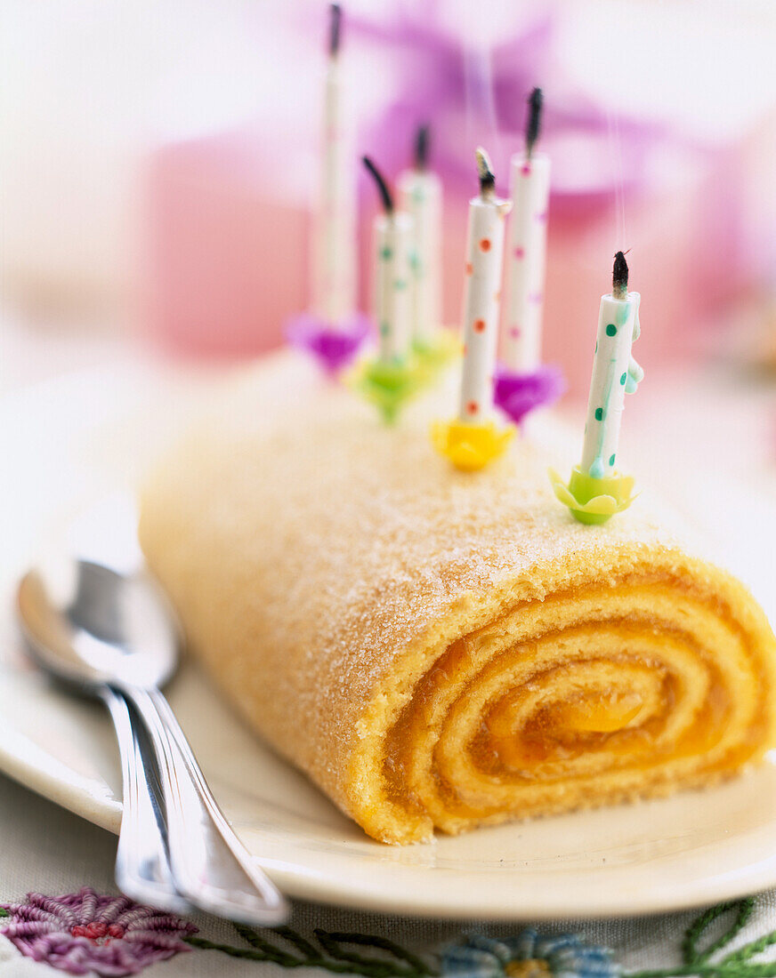 Apricot jam Swiss roll with candles