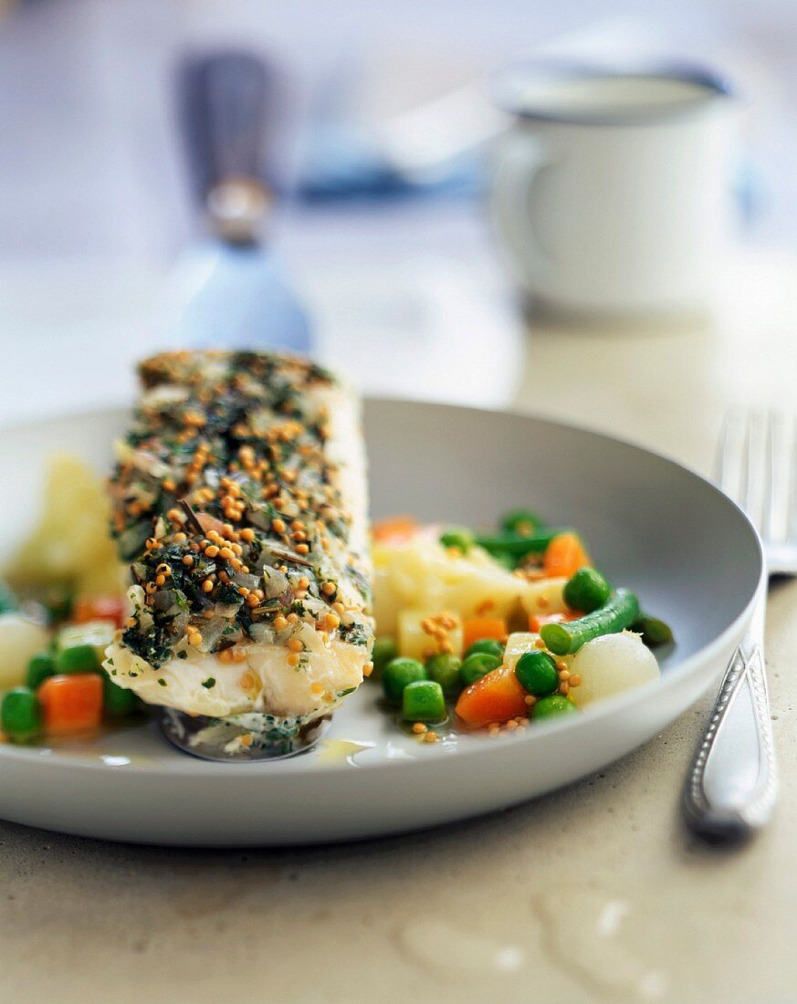 Piece of haddock with herbs and young vegetables