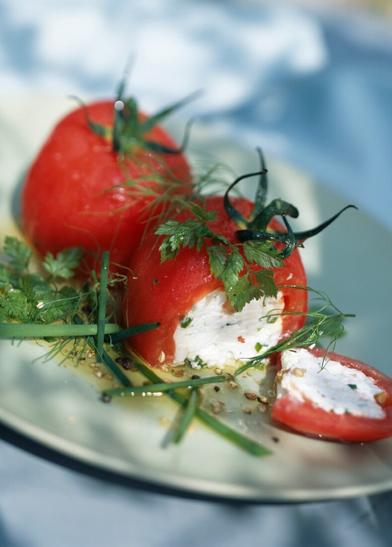 Peeled tomatoes stuffed with fresh goat's cheese