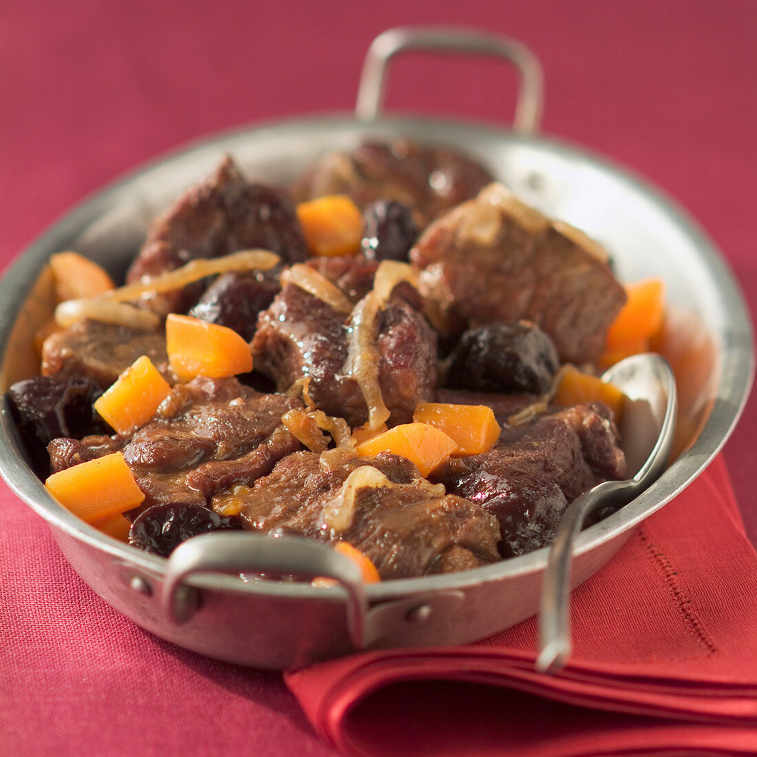 Stewed pork with prunes and carrots