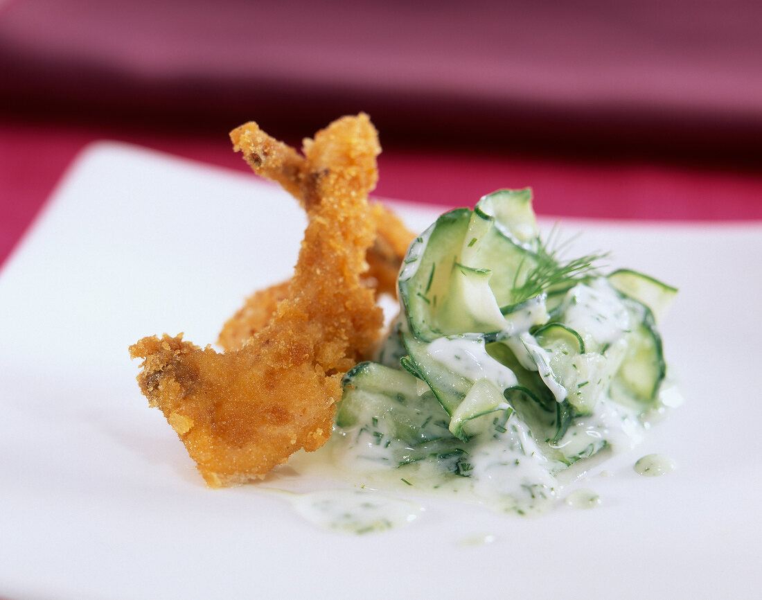 Rabbit coated in breadcrumbs with cucumber in yoghurt