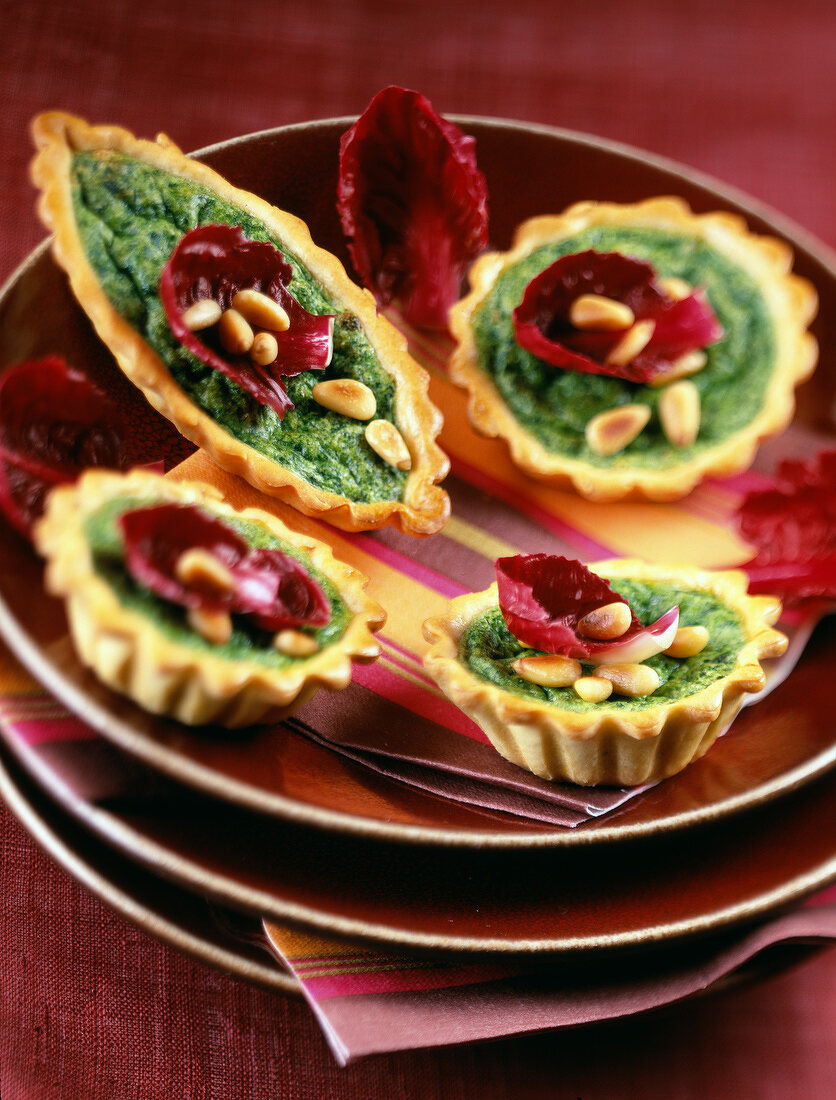 individual spinach and pine nut tarts