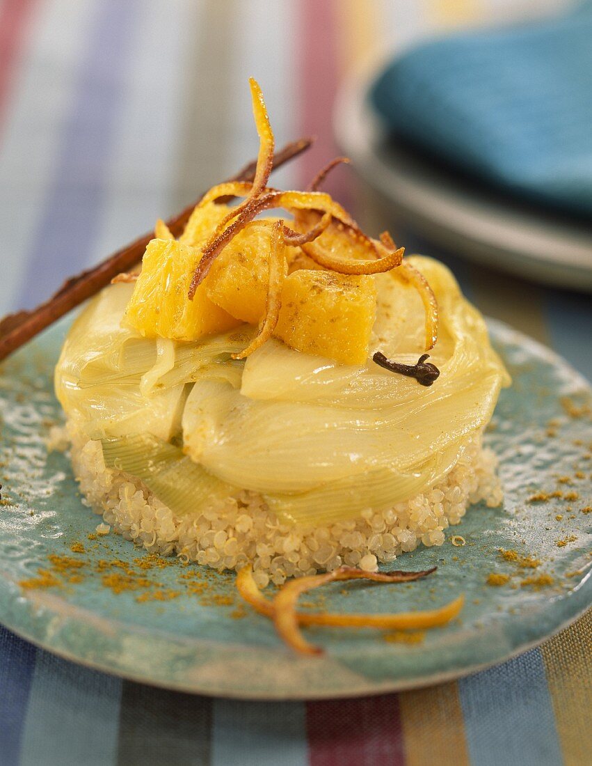 small onions in orange sauce on a bed of quinoa