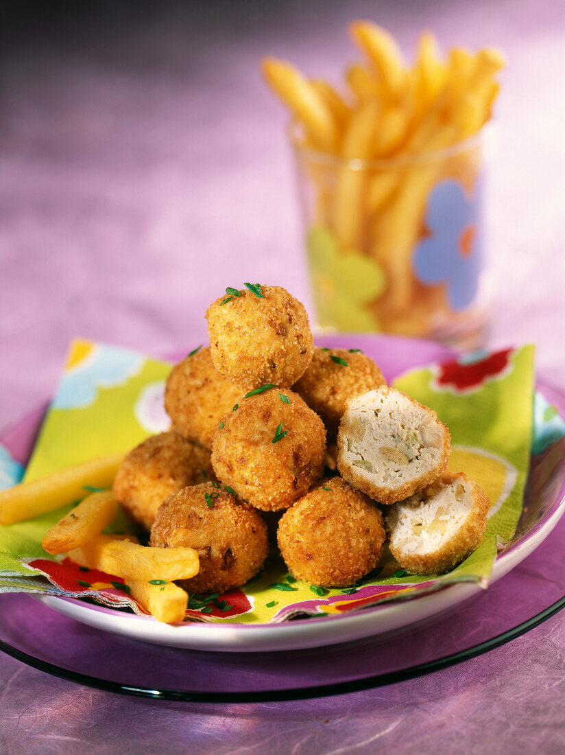 Putenkroketten mit Oliven, dazu Pommes frites