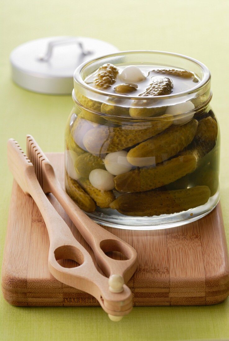 Jar of gherkins with pincers