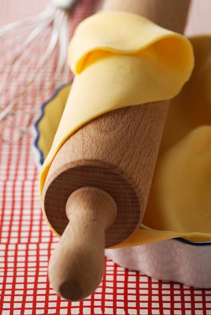 Uncooked pastry on rolling pin