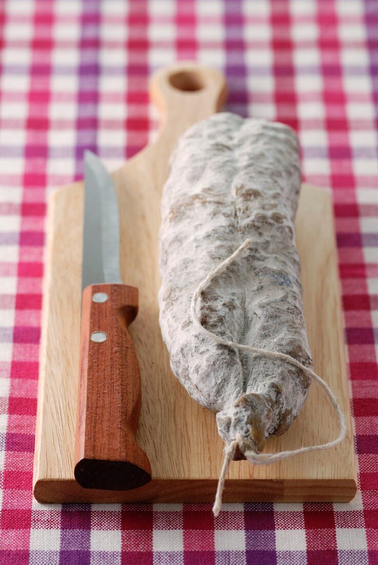 Dried sausage on chopping board