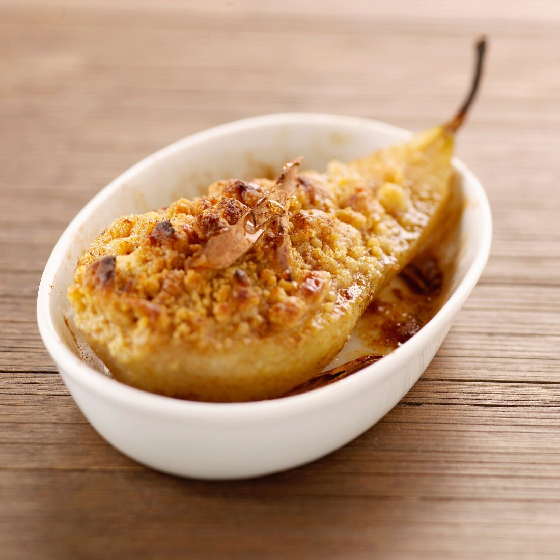 Roasted pear garnished with spicy crumble