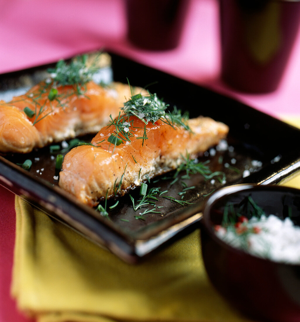 Pieces of salmon with dill cooked on one side a la plancha
