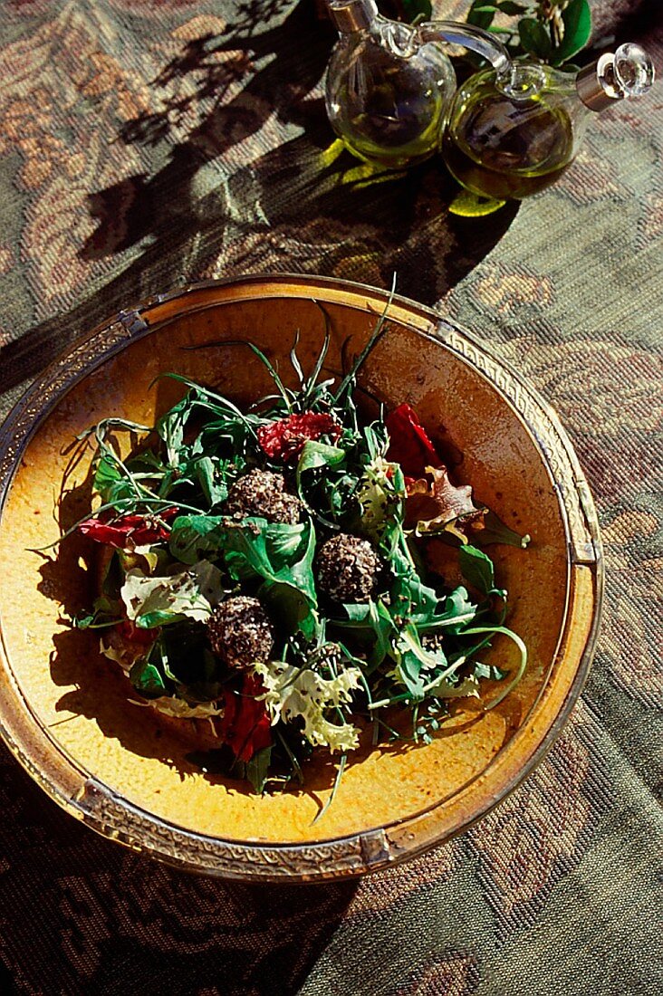 Brousse cream cheese balls on a mixed leaf salad with mushrooms