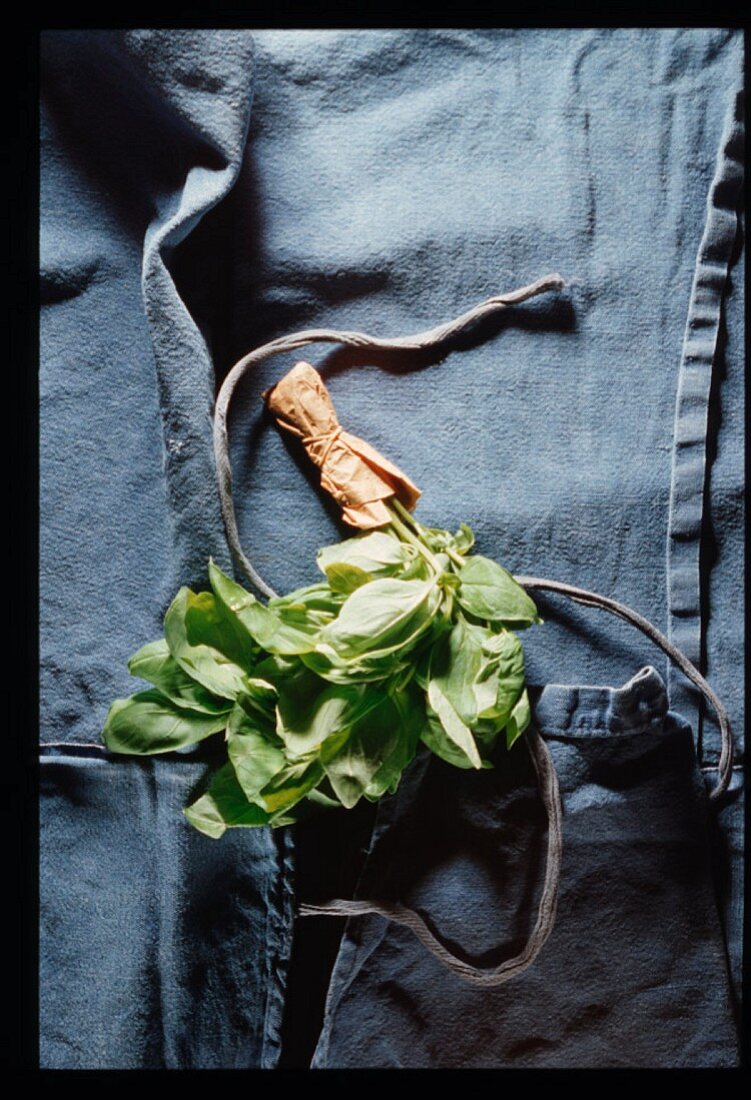 An apron and a bunch of basil