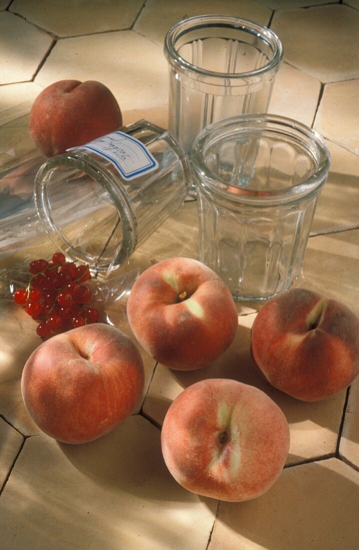 Peaches, redcurrants and jars of jam