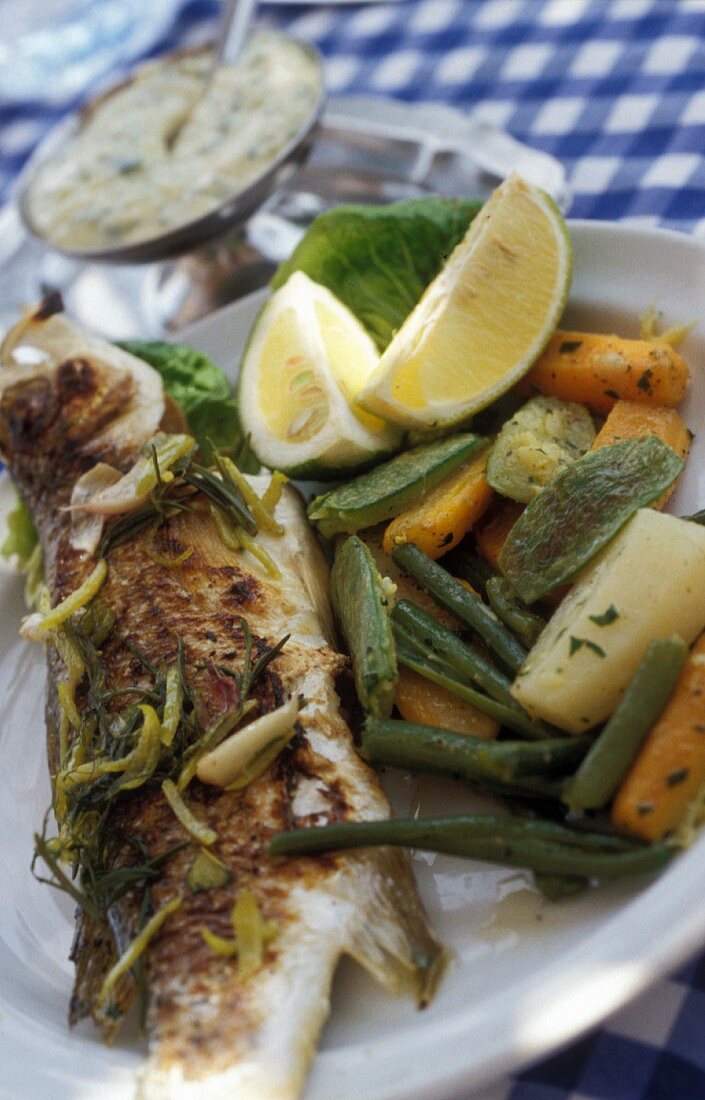 Grilled branzini with herbs and vegetables