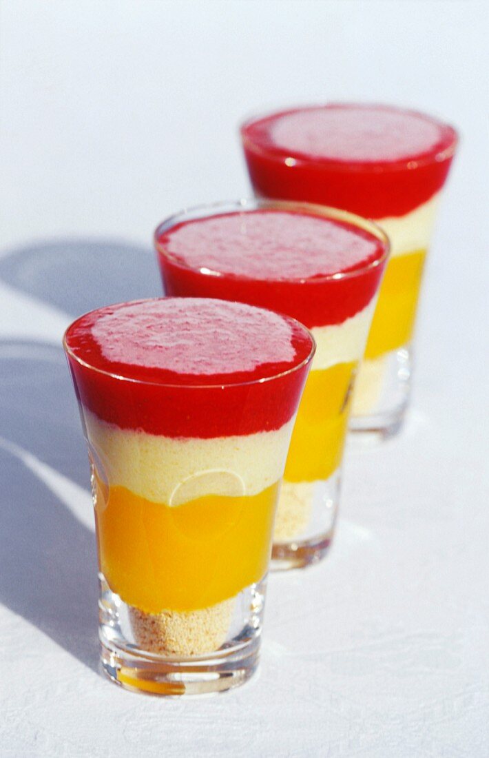 A layered dessert with mango and strawberries