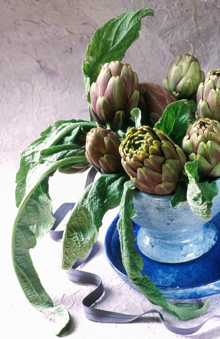 Poivrade artichokes in a blue ceramic vase