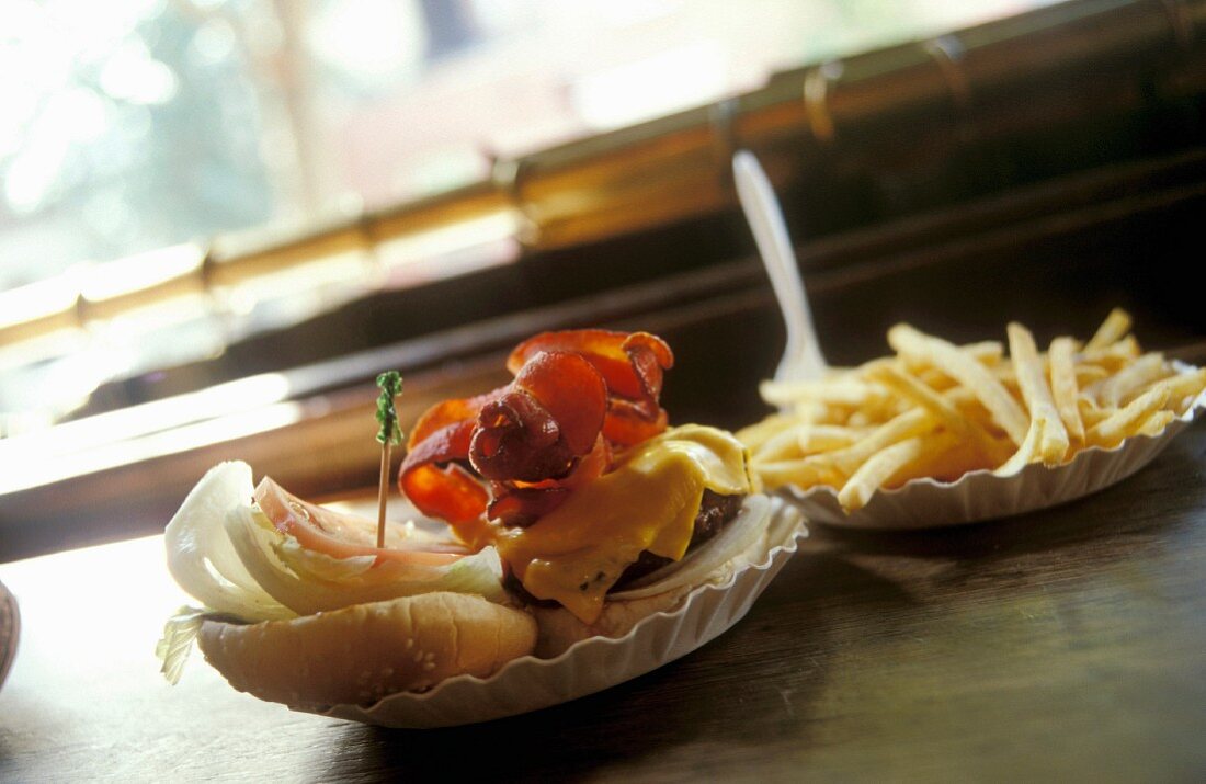 A hamburger and fries on a bar