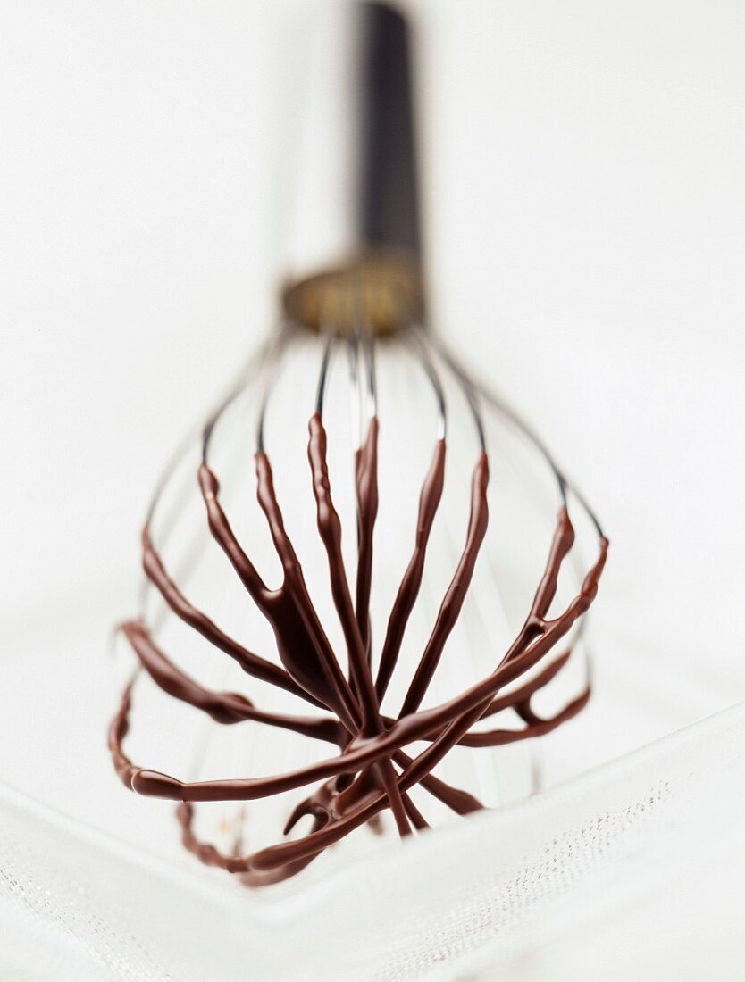 Whisk with melted chocolate