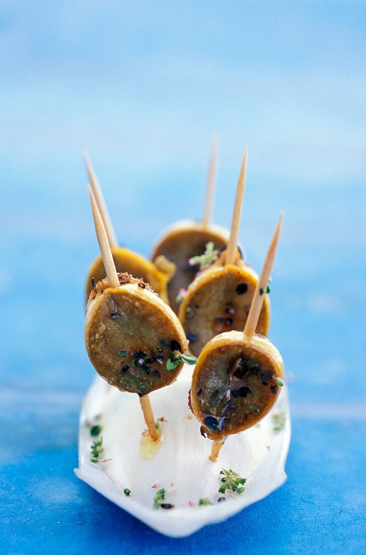 Limpet skewers with thyme flowers